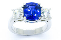 Ceylonese cushion cut sapphire with cushion cut diamonds set in Platinum