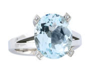 Oval aquamarine with round brilliant diamonds as accents set in 18ct white gold