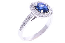 Cushion cut Ceylonese sapphire with round brilliant diamonds set in 18ct white gold