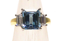 Step cut Aquamarine with trapezoid diamonds set in Platinum & 18ct yellow gold